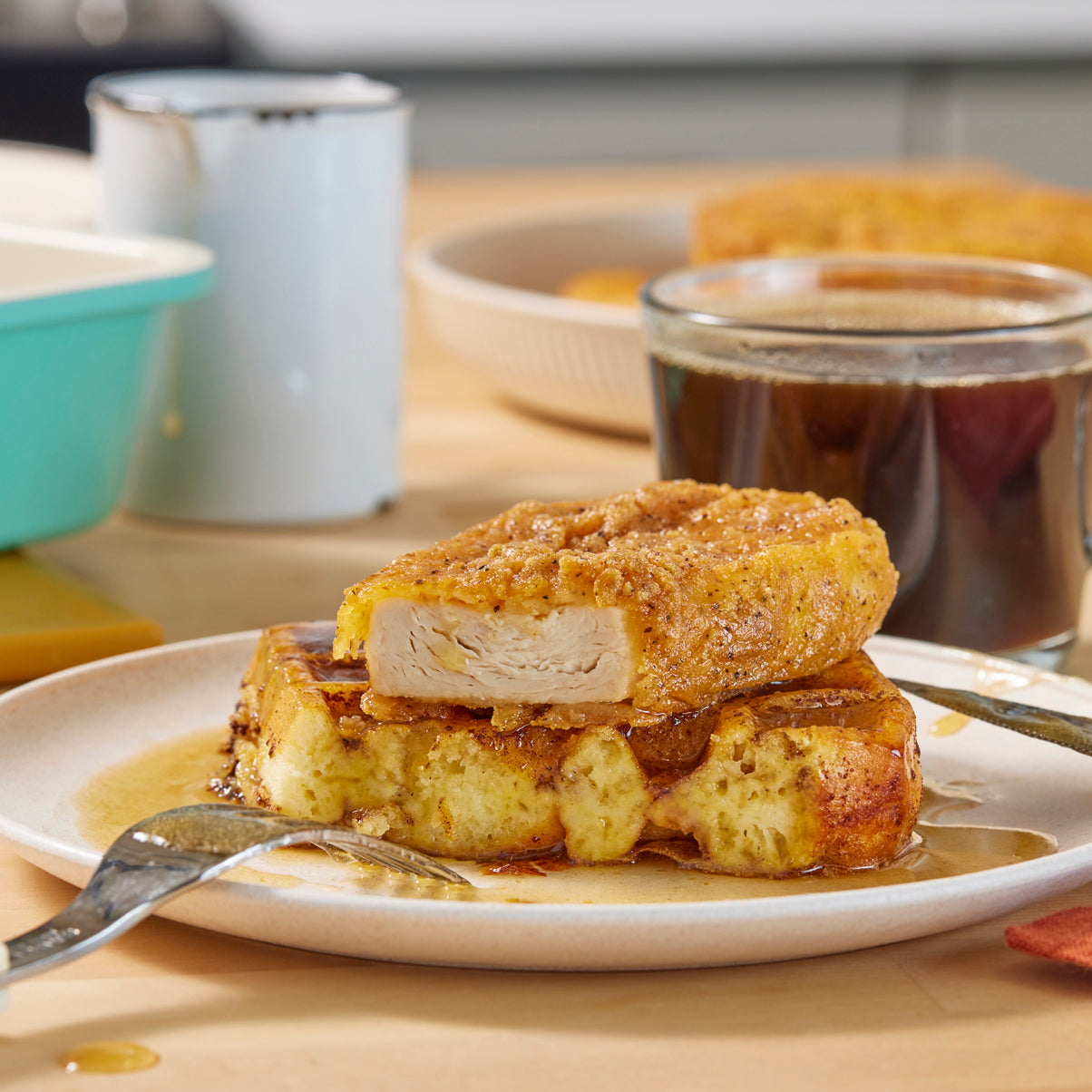 a plate with waffle topped with meati crispy cutlet cut in half.